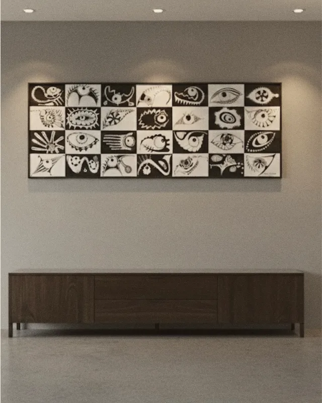 Painel em preto e branco com olhos e formas sobre um aparador