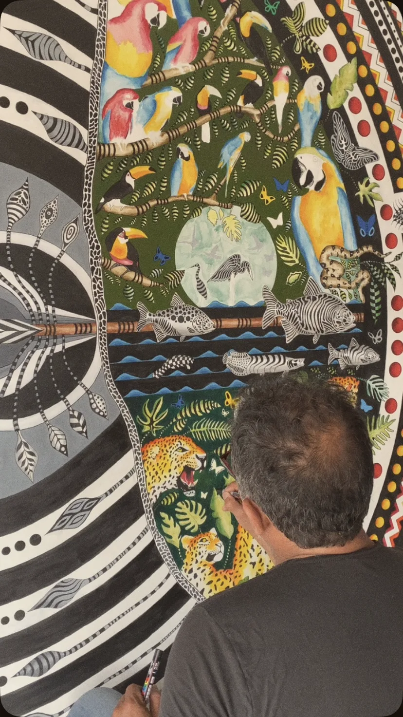 Almir pintando um mural com bichos da Amazônia